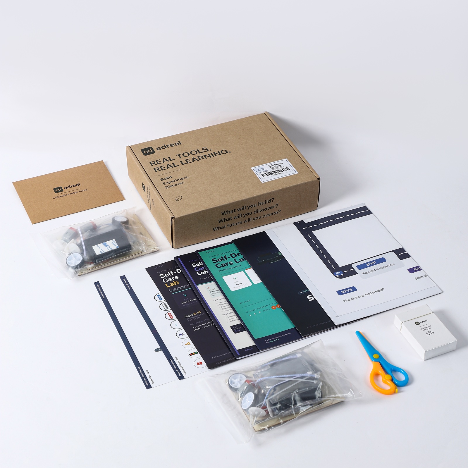 Self-Driving Cars Lab box, curriculum books, route board, cards, tools, and vehicle-building materials